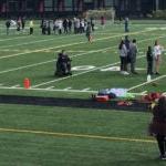 People stand on an athletic field