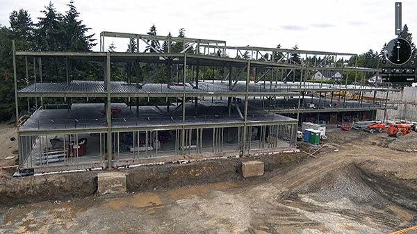 a three story structure under construction with just steel beams