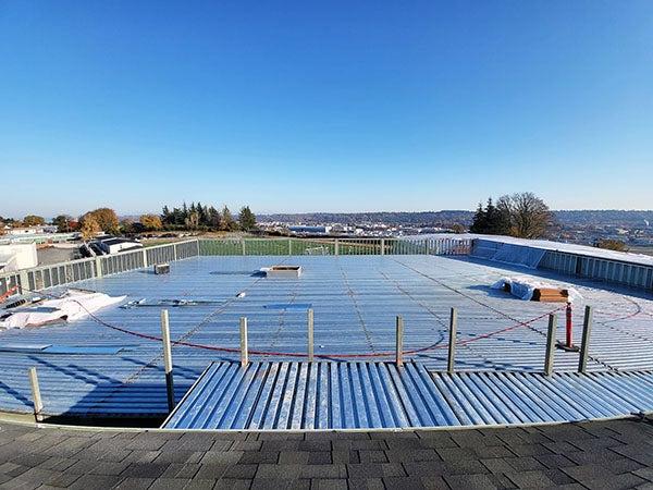 a larg metal roof with a playfield in the distrance