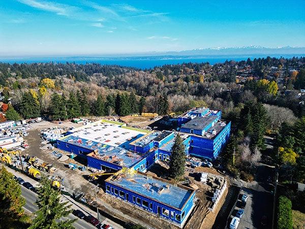 aerial view of a large building with blue walls and flat roofs