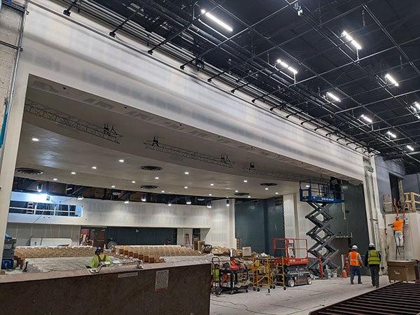 a stage area under construction with an opening out to theater seats