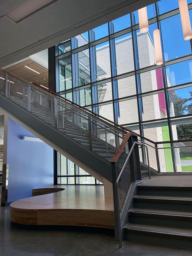 looking toward a stairway leading up in front of windows with a wooden platform underneath