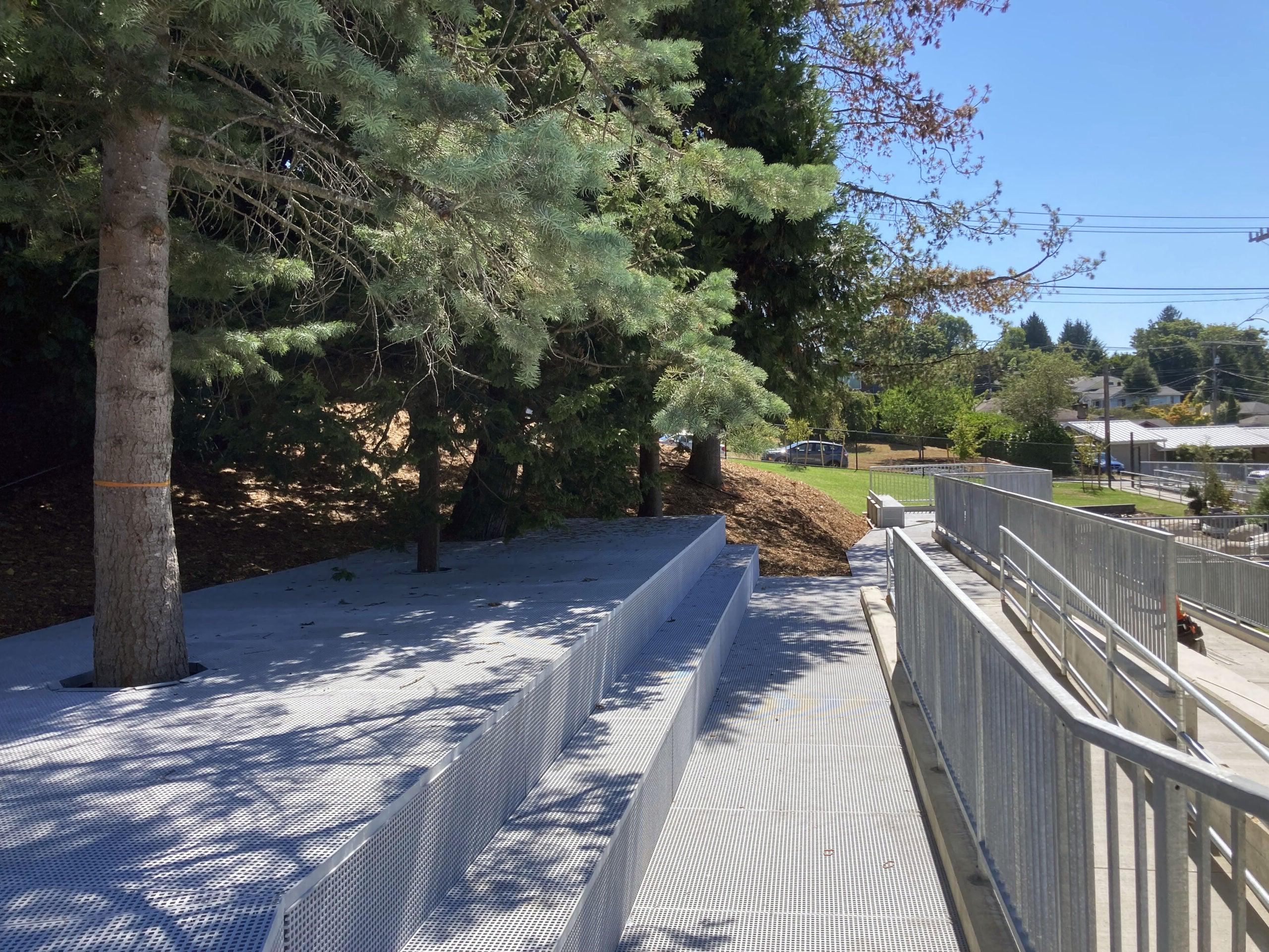 a ramp and walkway set into a hillside