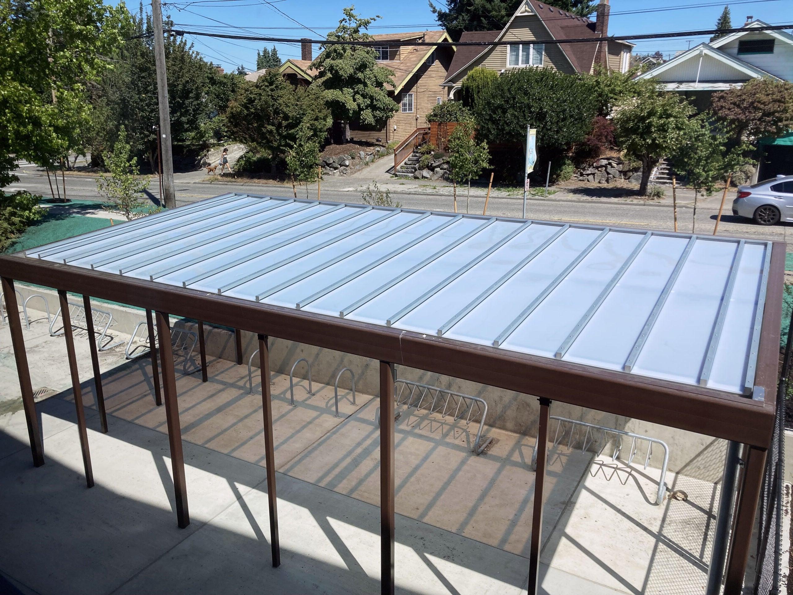 looking down at a white roof on a bike shelter