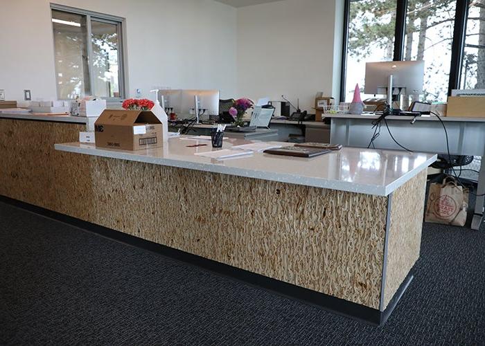 a room with a counter that has a textured wood front