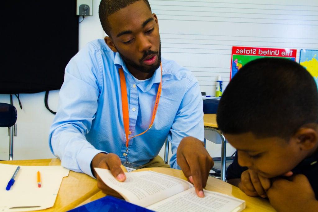 Tutor and student working on reading.