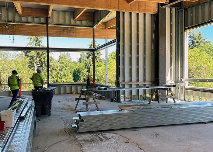 inside a partially built room with wood beams and steel framing