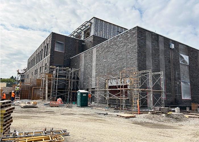 outside of a brick building under construction with scaffolding