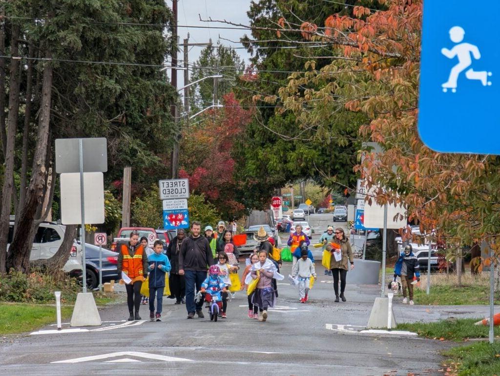 Students and families walk to school on "Stay Healthy" street.