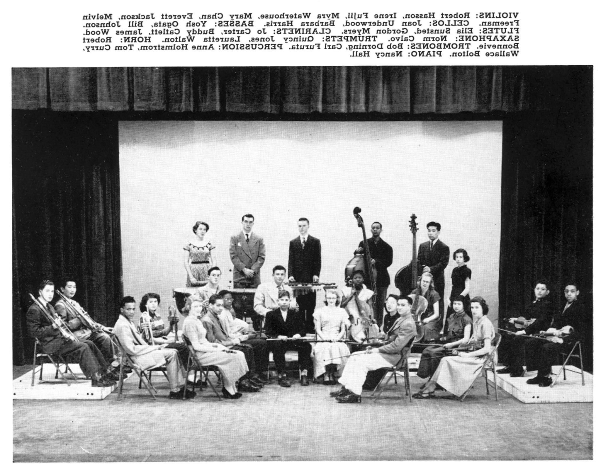 Quincy Jones sits with trumpet along with other students with instruments in the orchestra